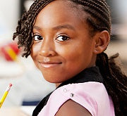 A smiling student with a pencil