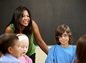 A smiling educator with students