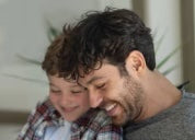 A smiling dad with his son