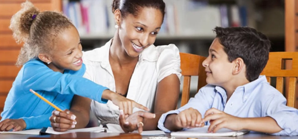 A woman teaching two children with notebooks and a pencil